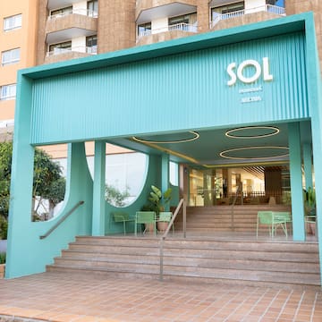 a building with stairs and a blue awning