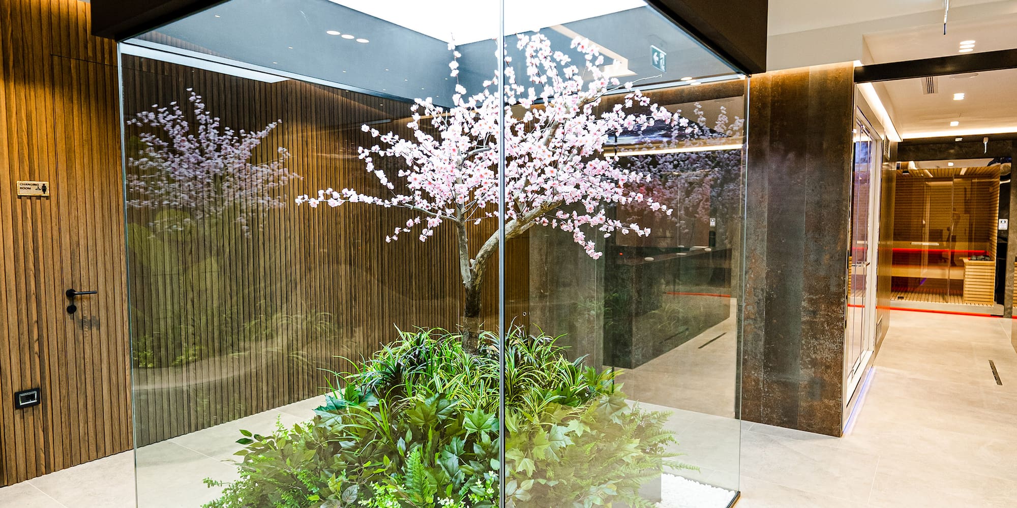 a glass enclosure with plants in it