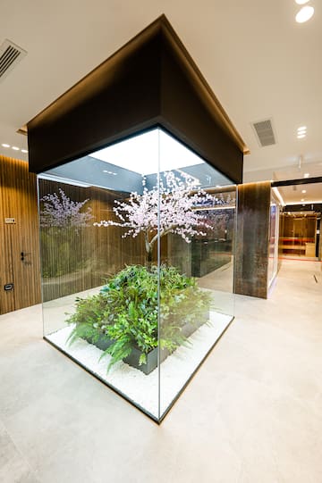 a glass enclosure with plants in it