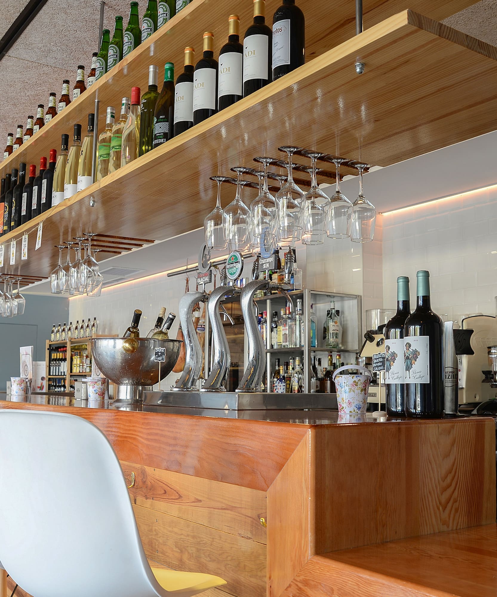a bar with wine glasses and bottles