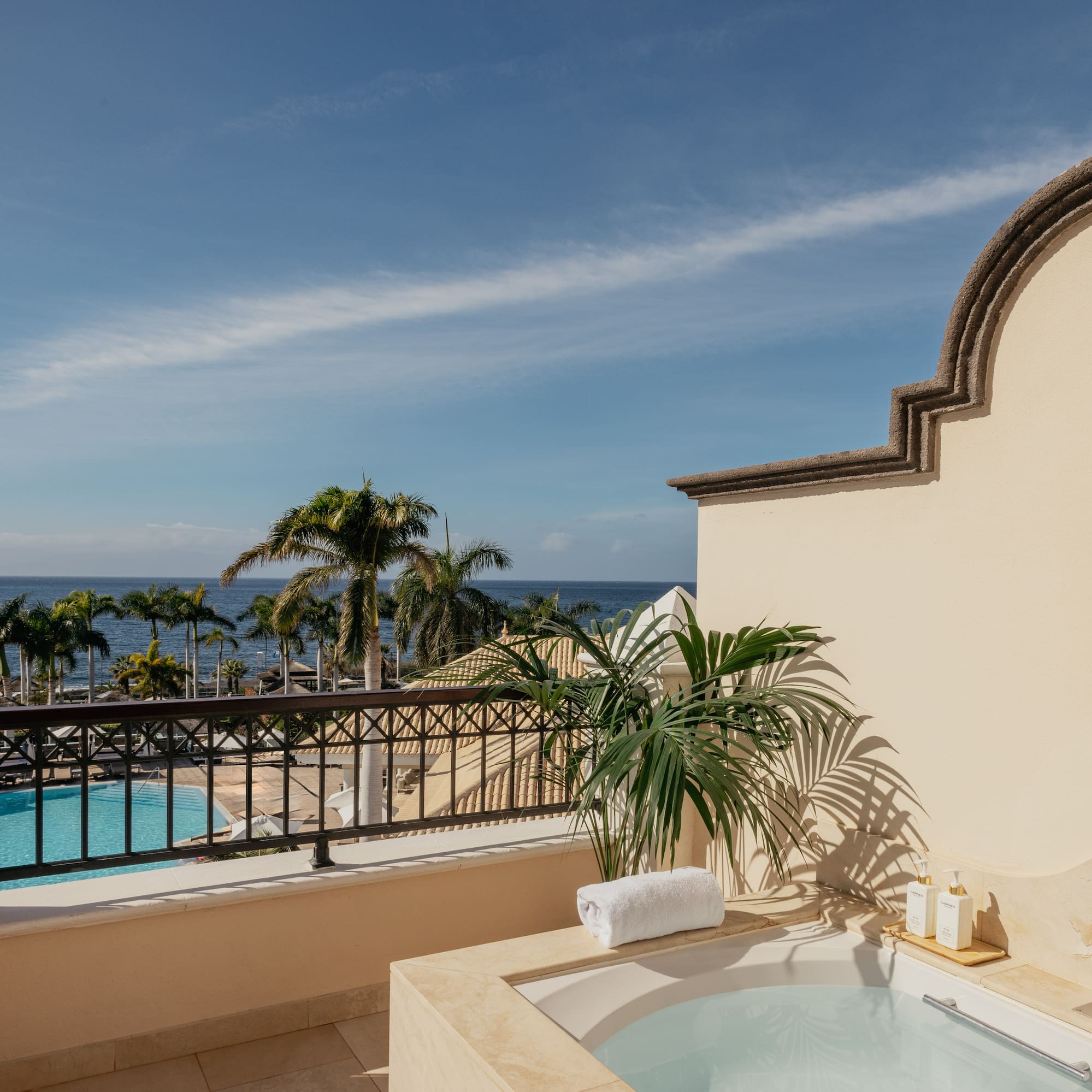 a hot tub with a pool in the background