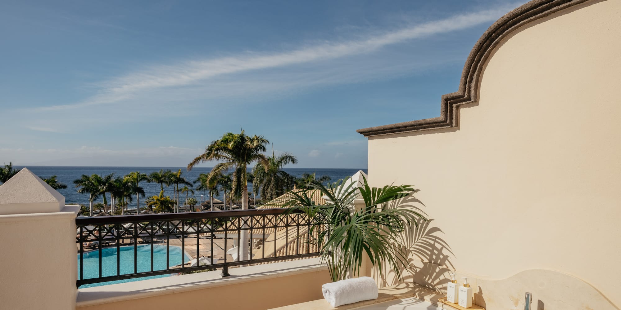 a hot tub with a pool in the background