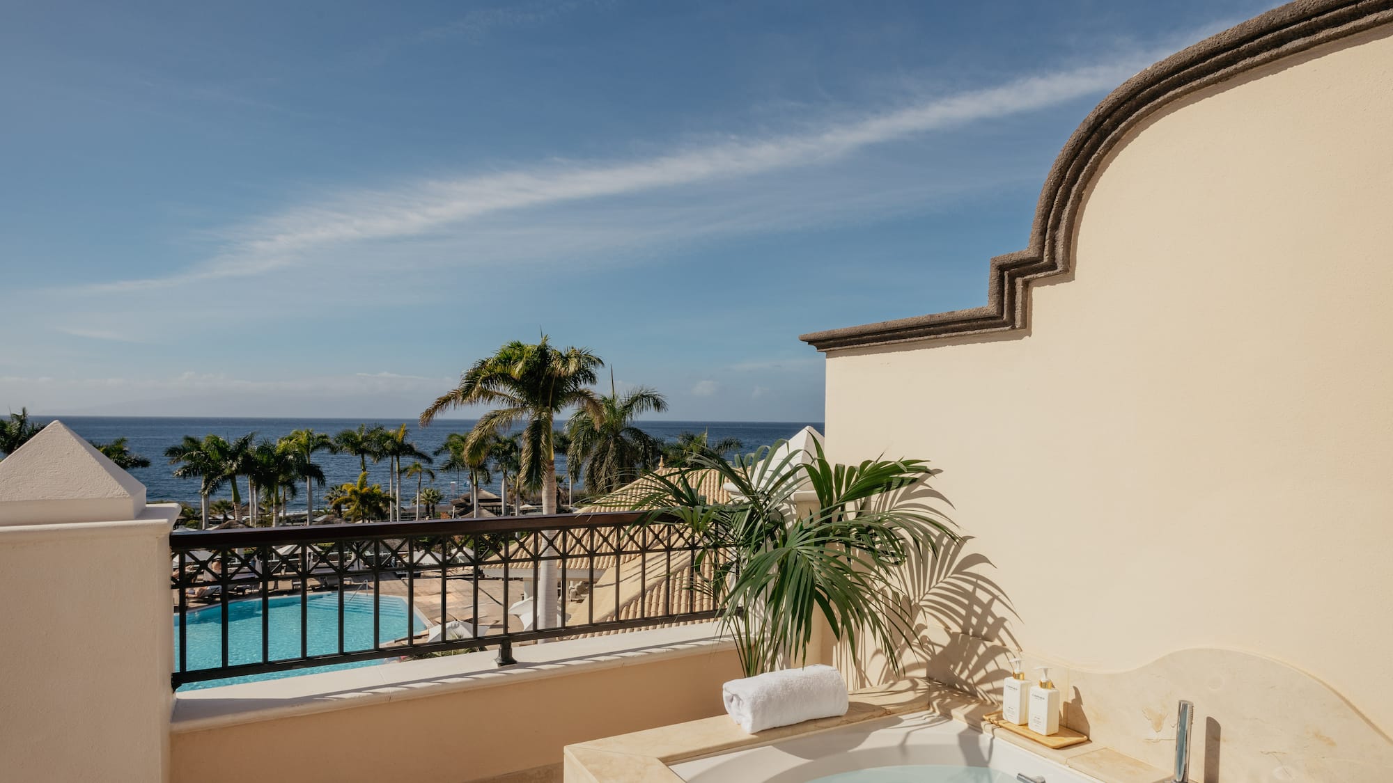 a hot tub with a pool in the background