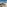 Hotel balcony with outdoor hot tub, ocean view, palm trees, and pool.