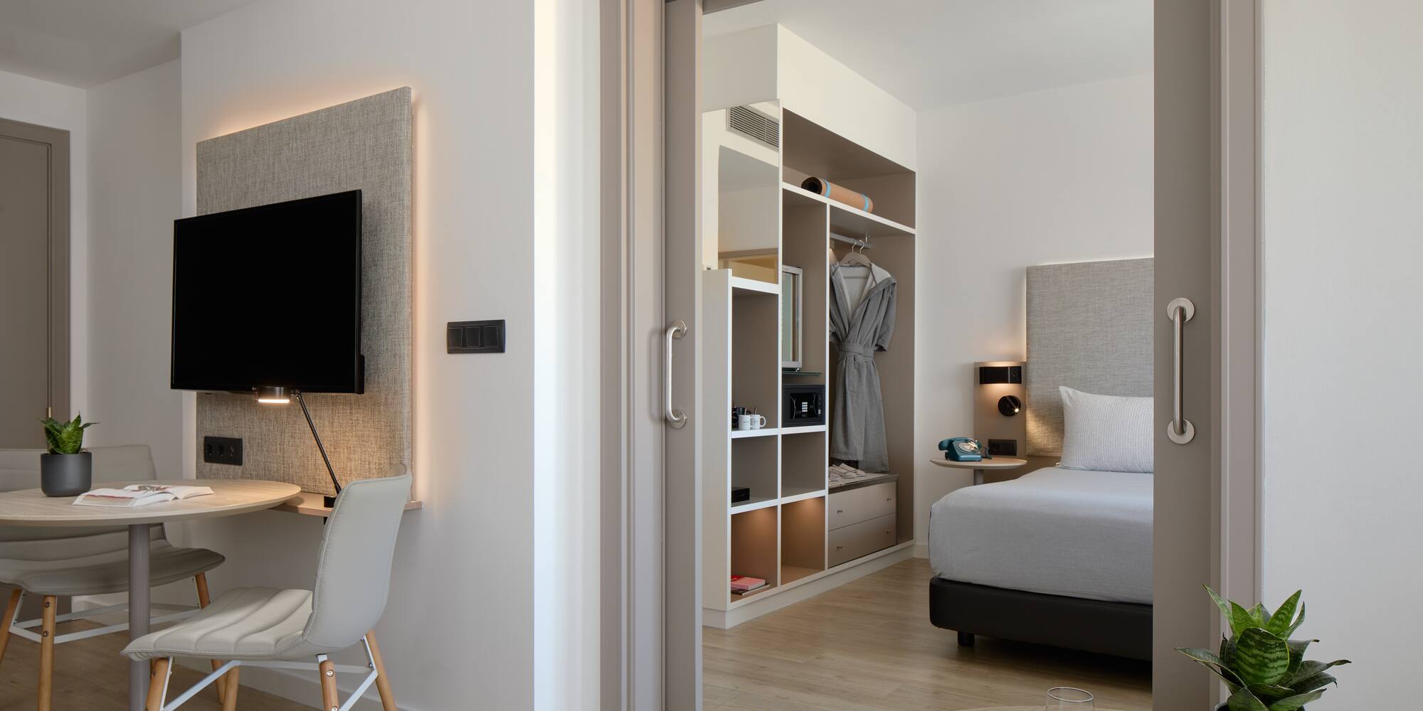 a bedroom with a tv and a desk