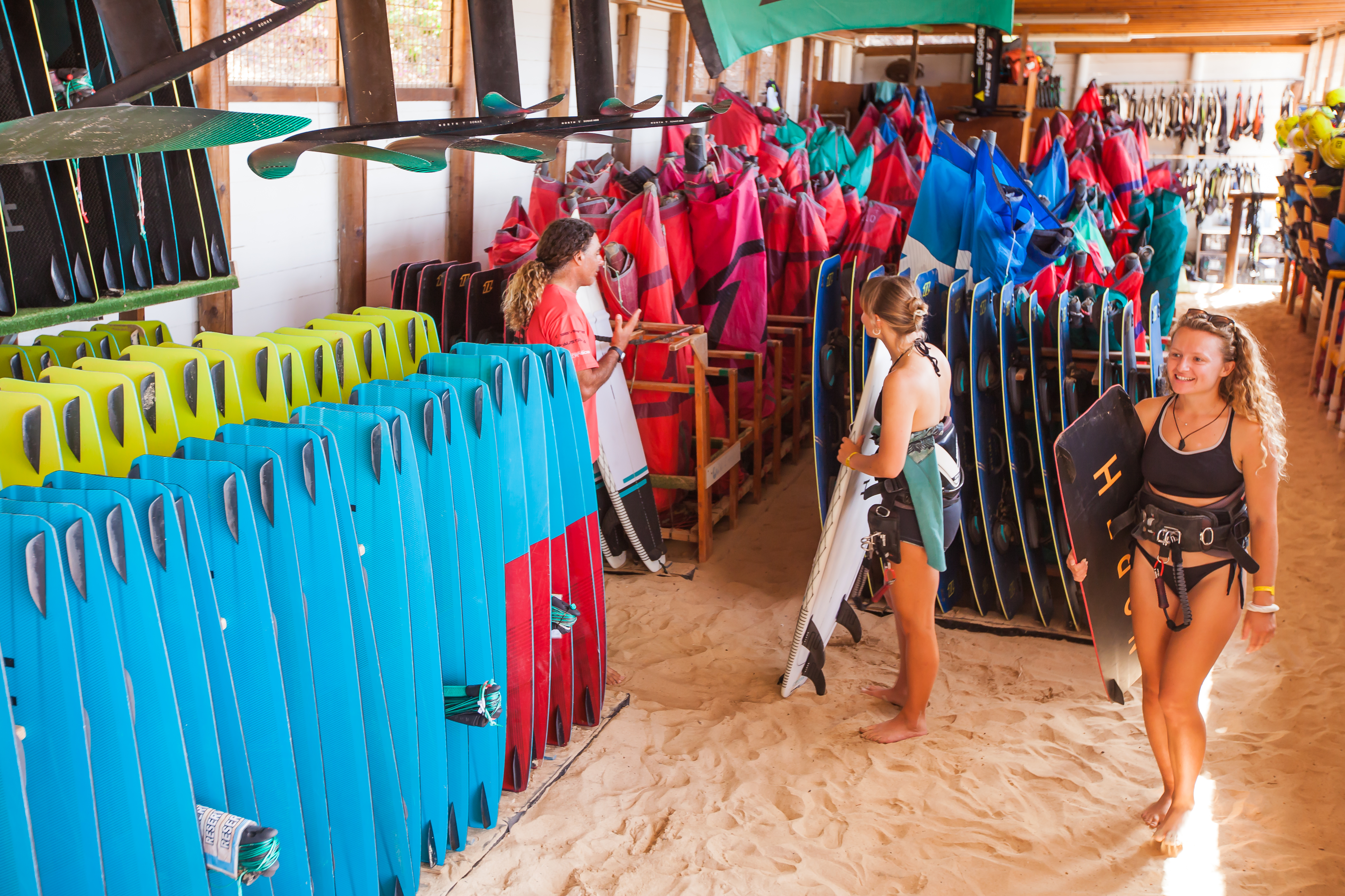 a woman holding a surfboard in a store