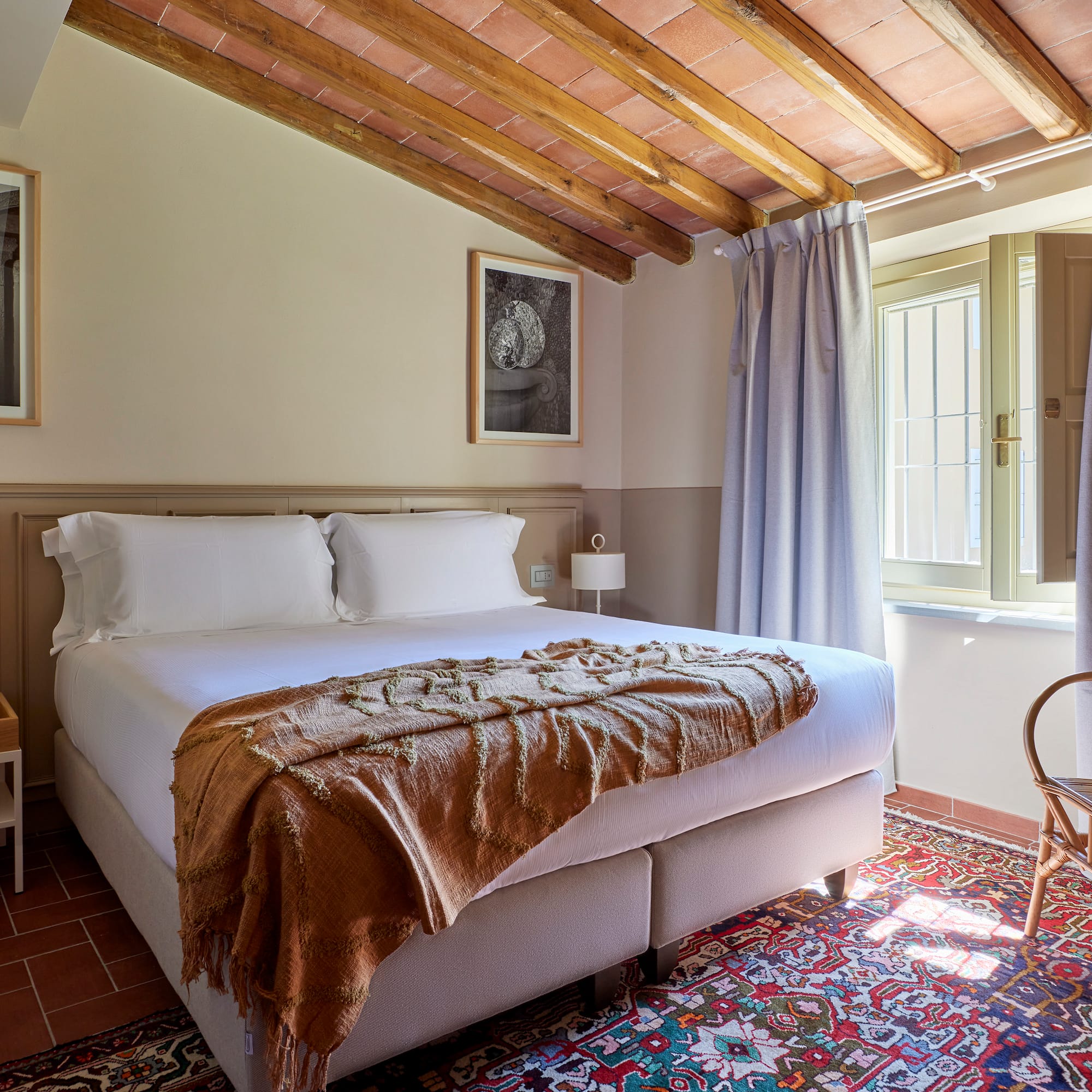 a bedroom with a bed and a chair