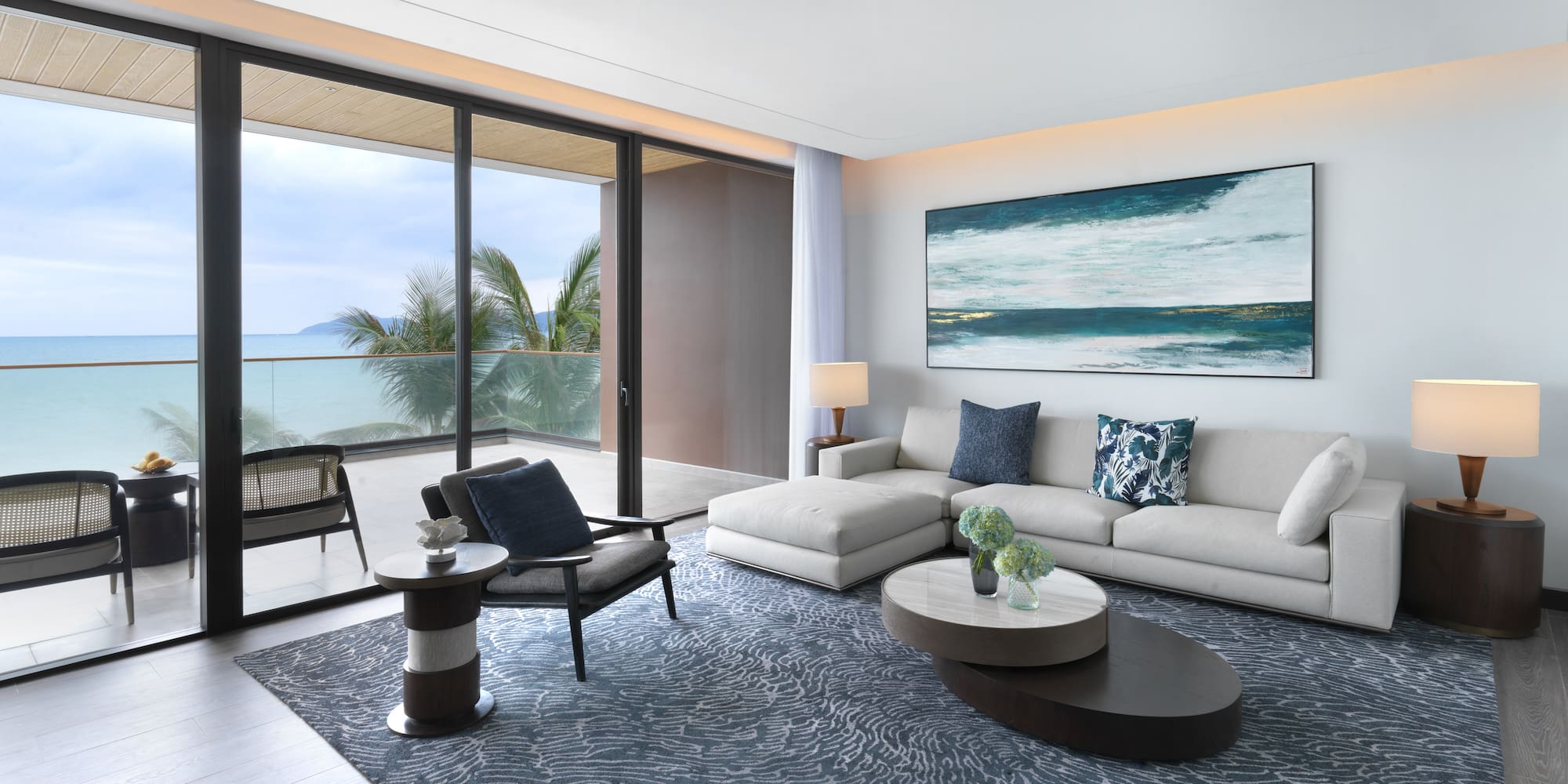 a living room with a large glass door and a large painting