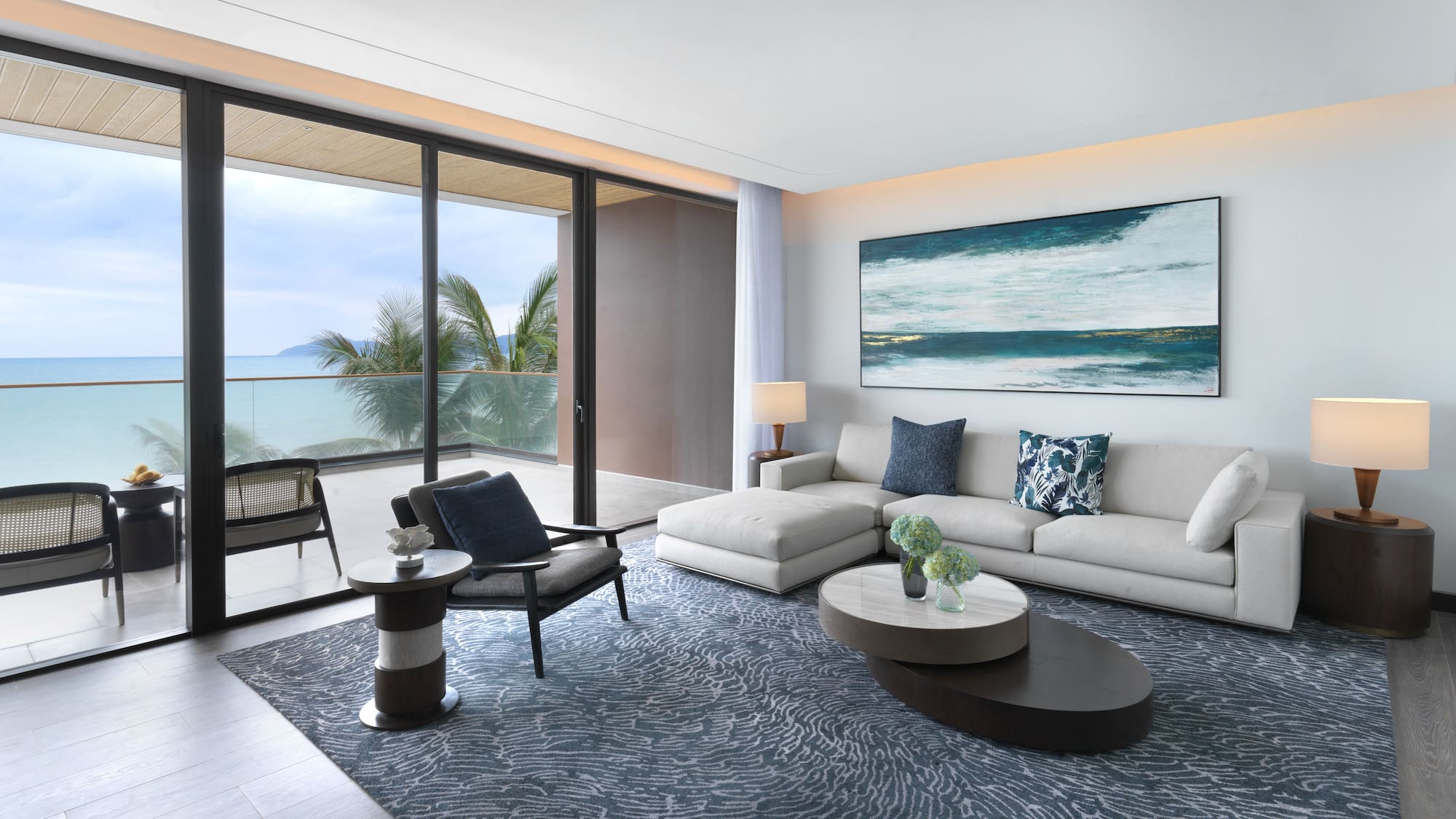 a living room with a large glass door and a large painting