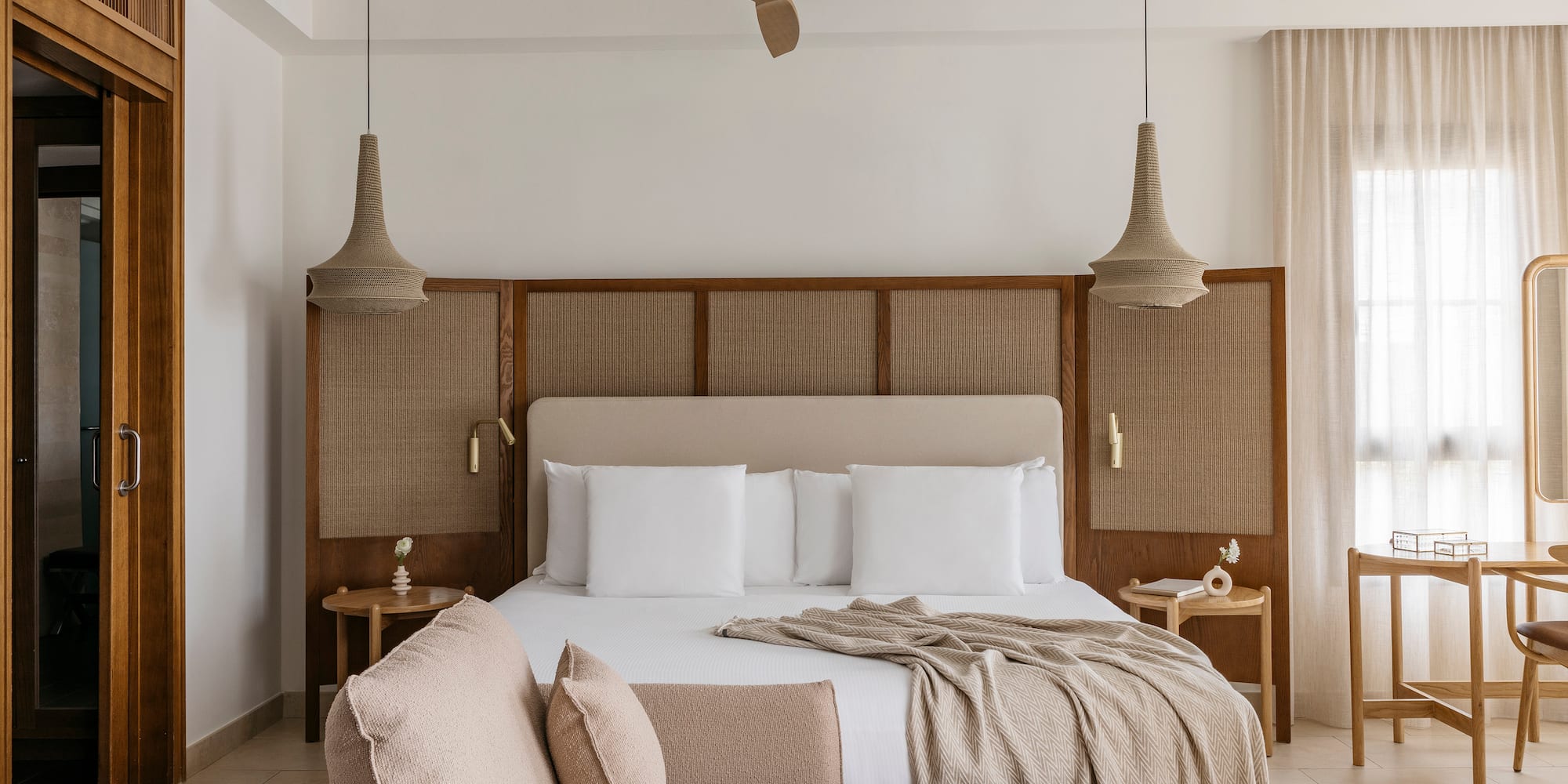 a bed with a fan and a couch