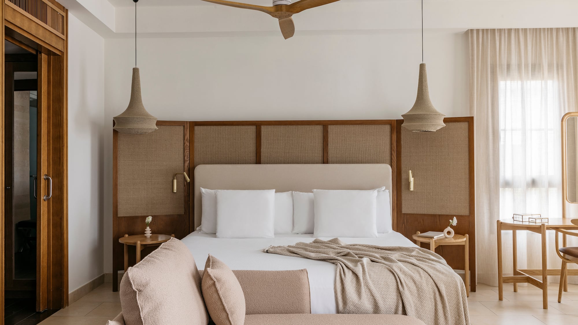 a bed with a fan and a couch