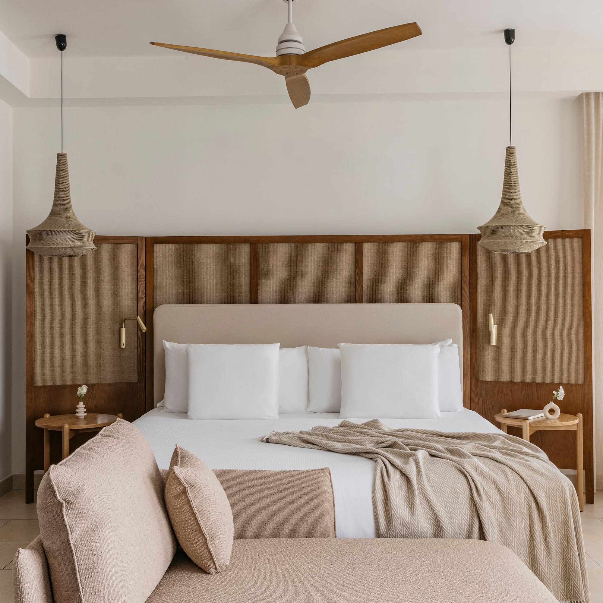 a bed with a fan and a couch