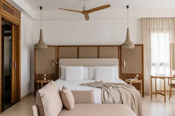 a bed with a fan and a couch