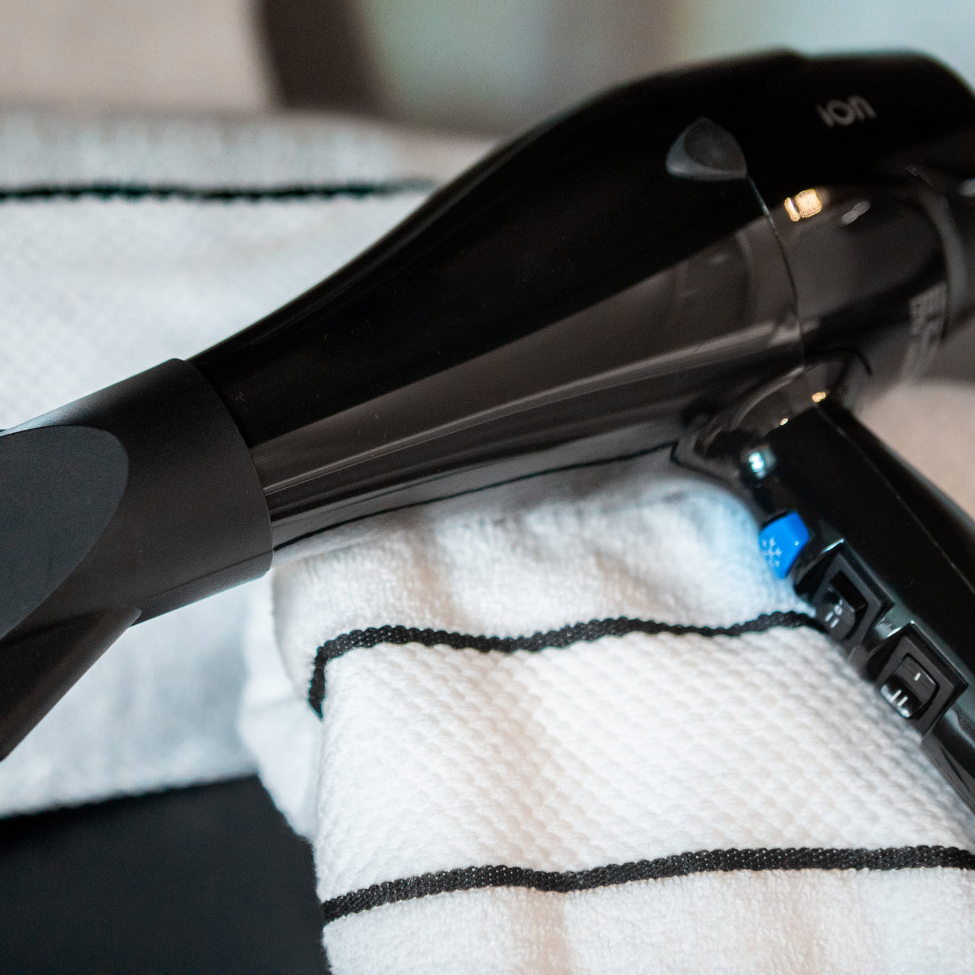 a black hair dryer on a towel