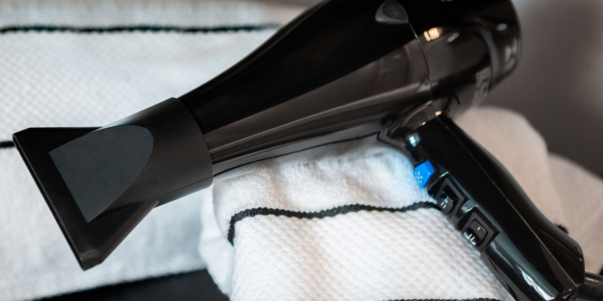 a black hair dryer on a towel