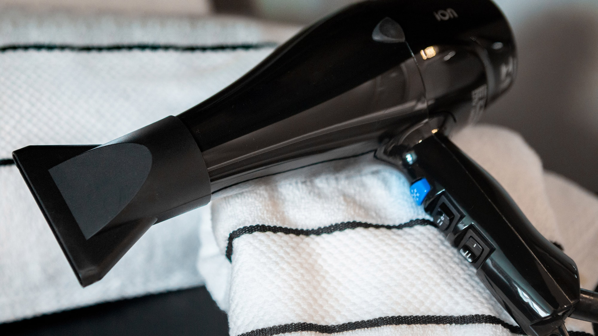 a black hair dryer on a towel
