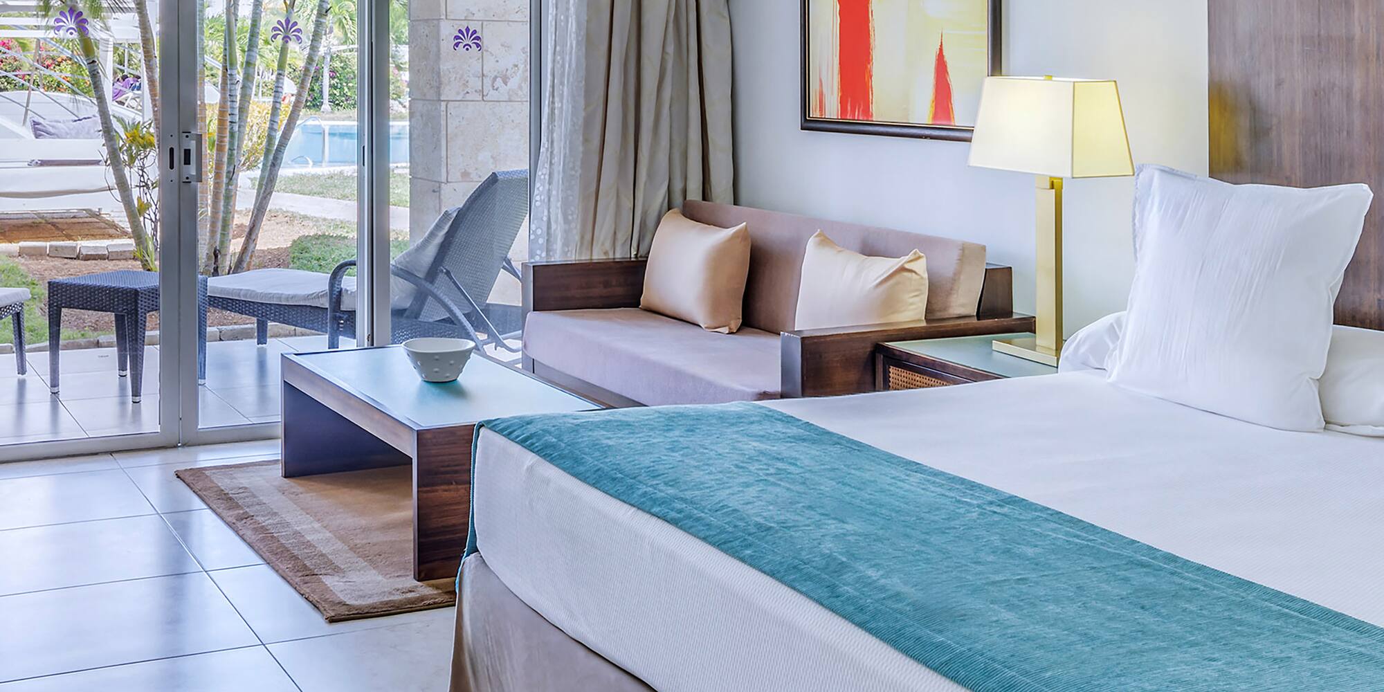 a room with a bed and a glass door