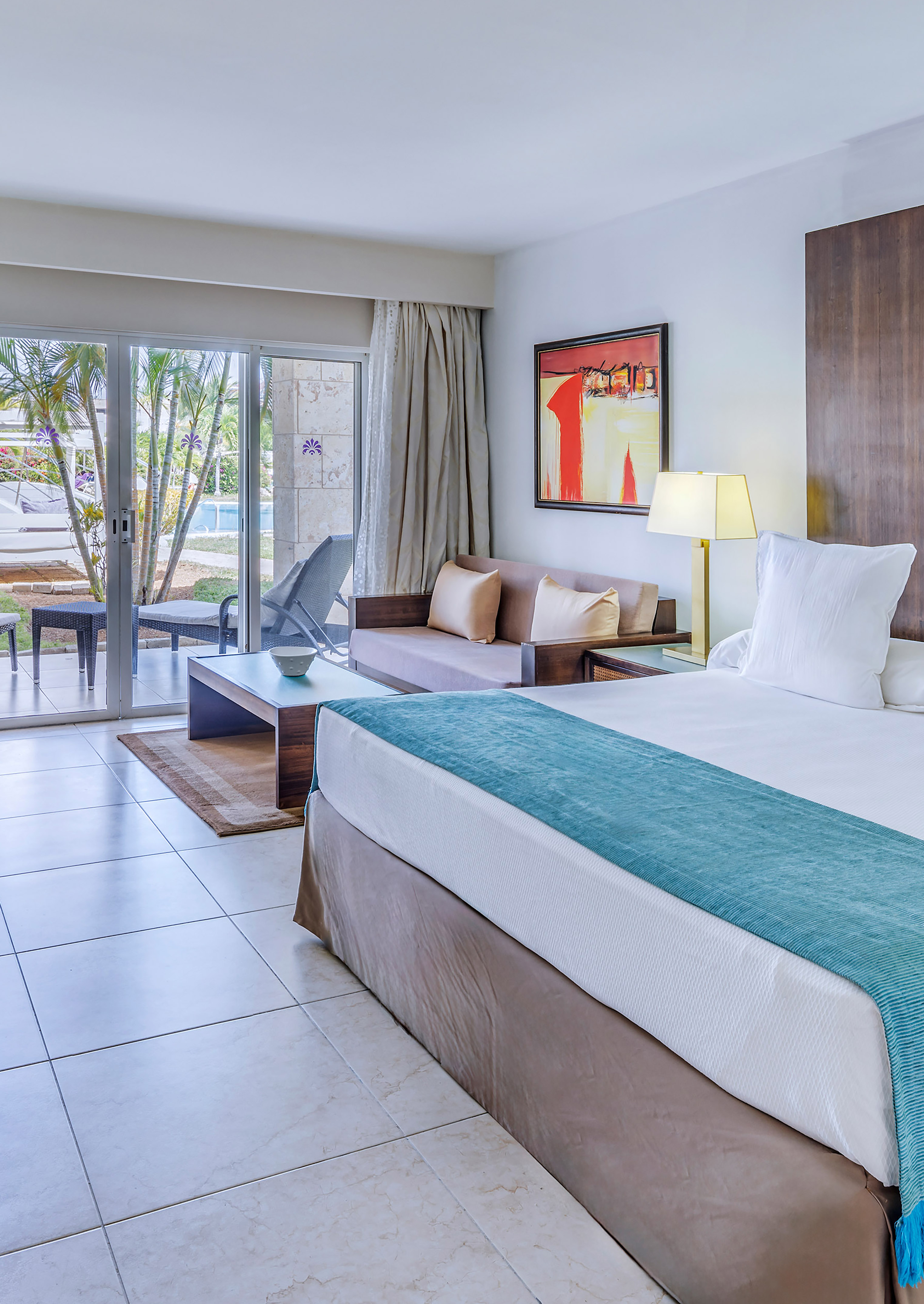 a room with a bed and a glass door