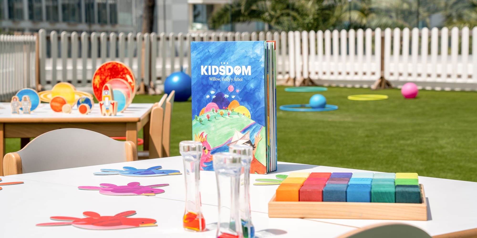 a table with a book and colorful objects on it