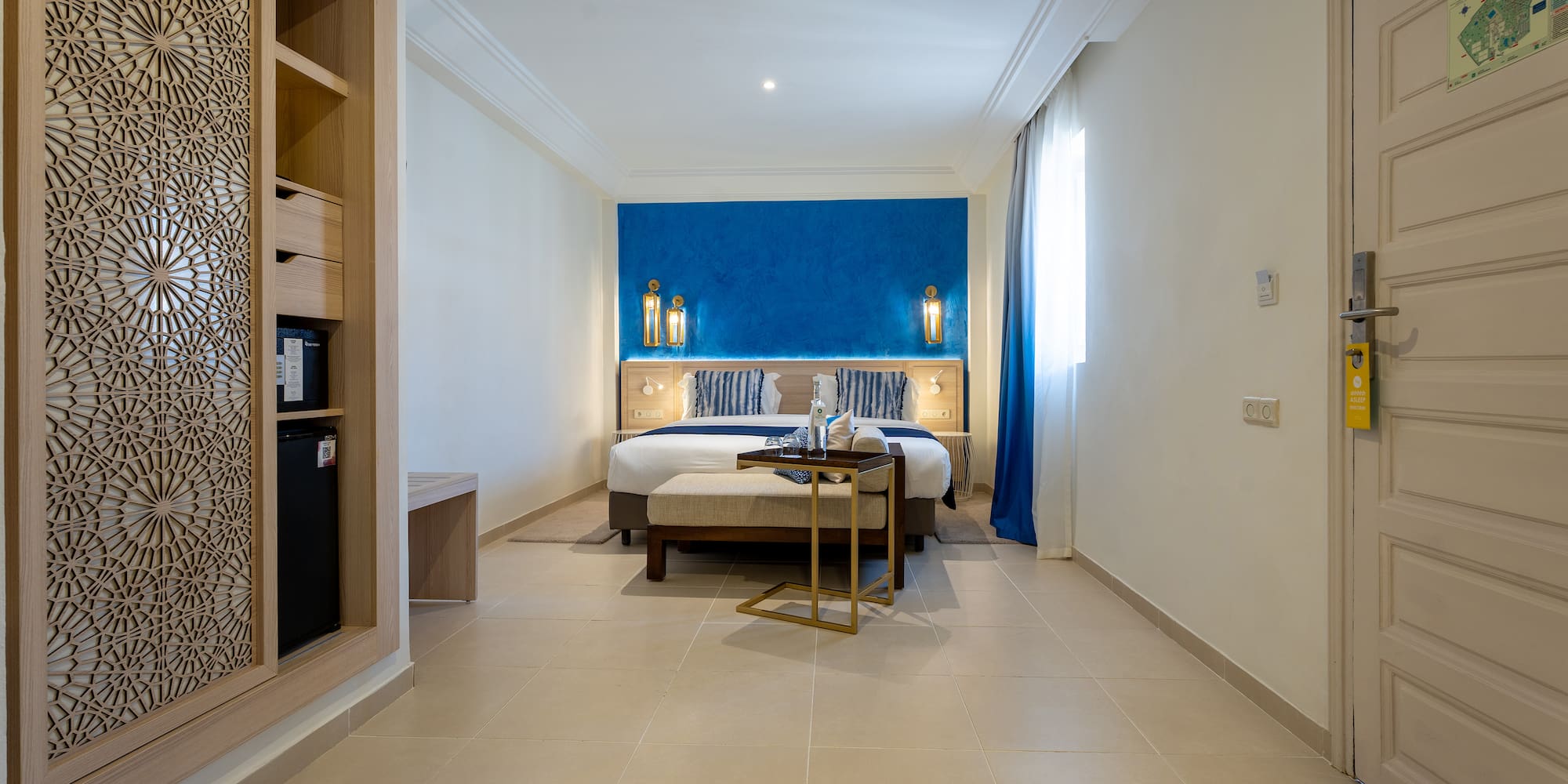 a room with a bed and a bookcase