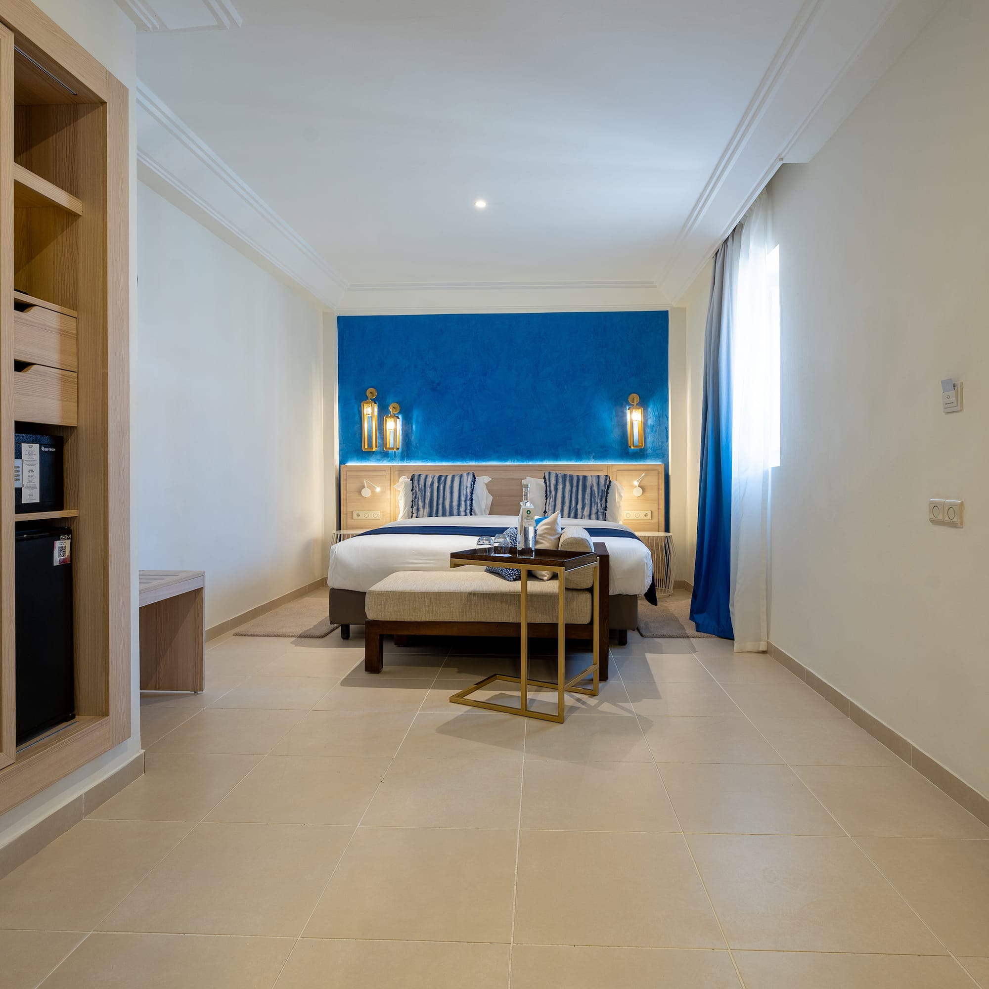 a room with a bed and a bookcase