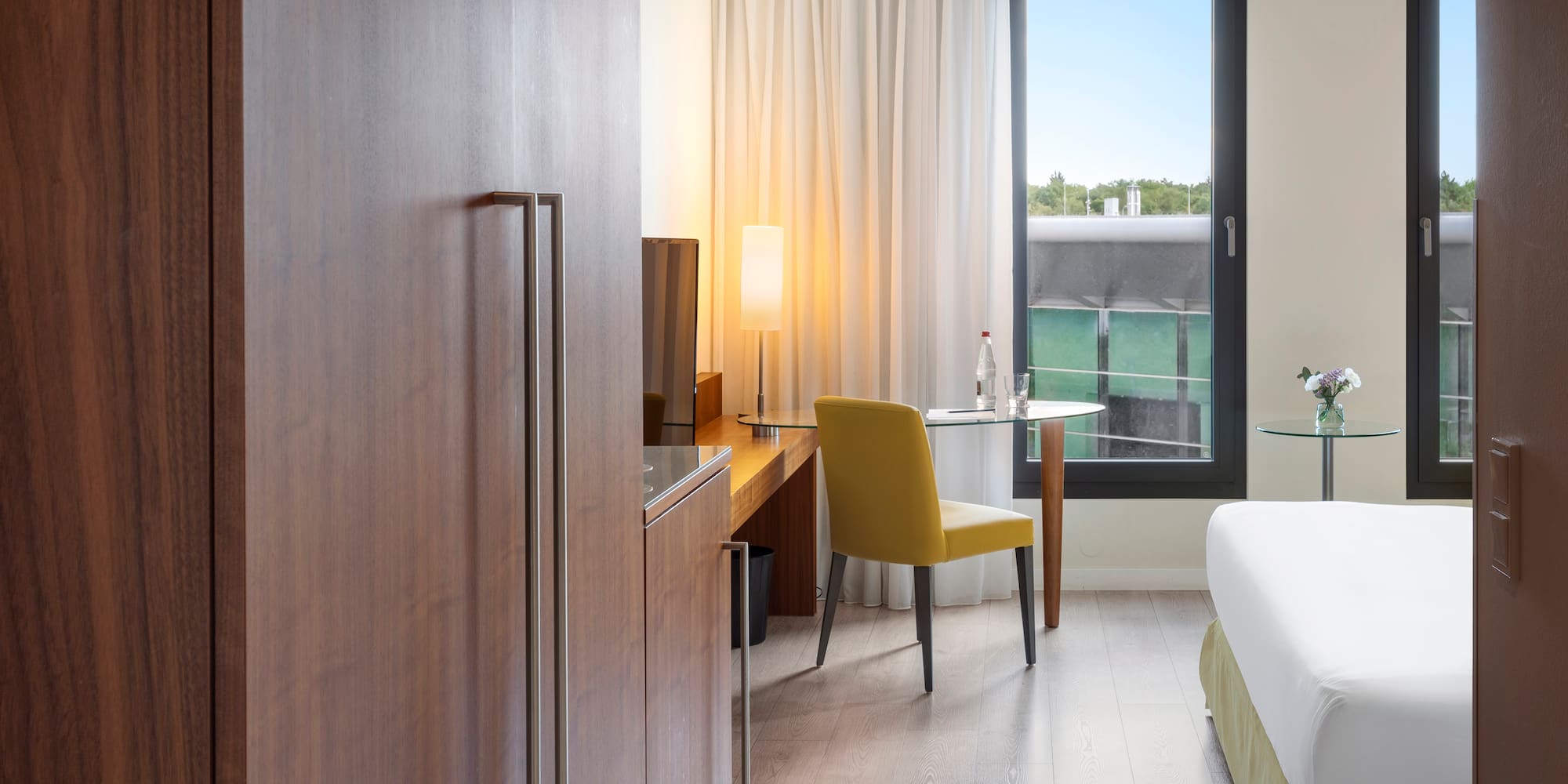 a room with a bed and a table and chair