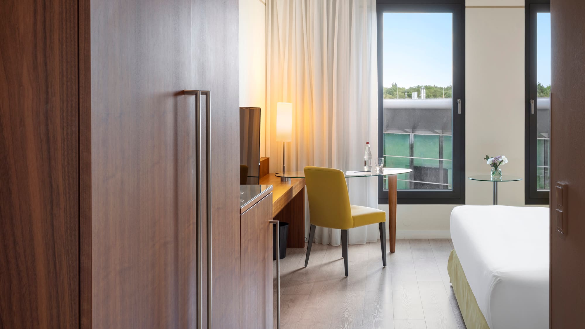 a room with a bed and a table and chair