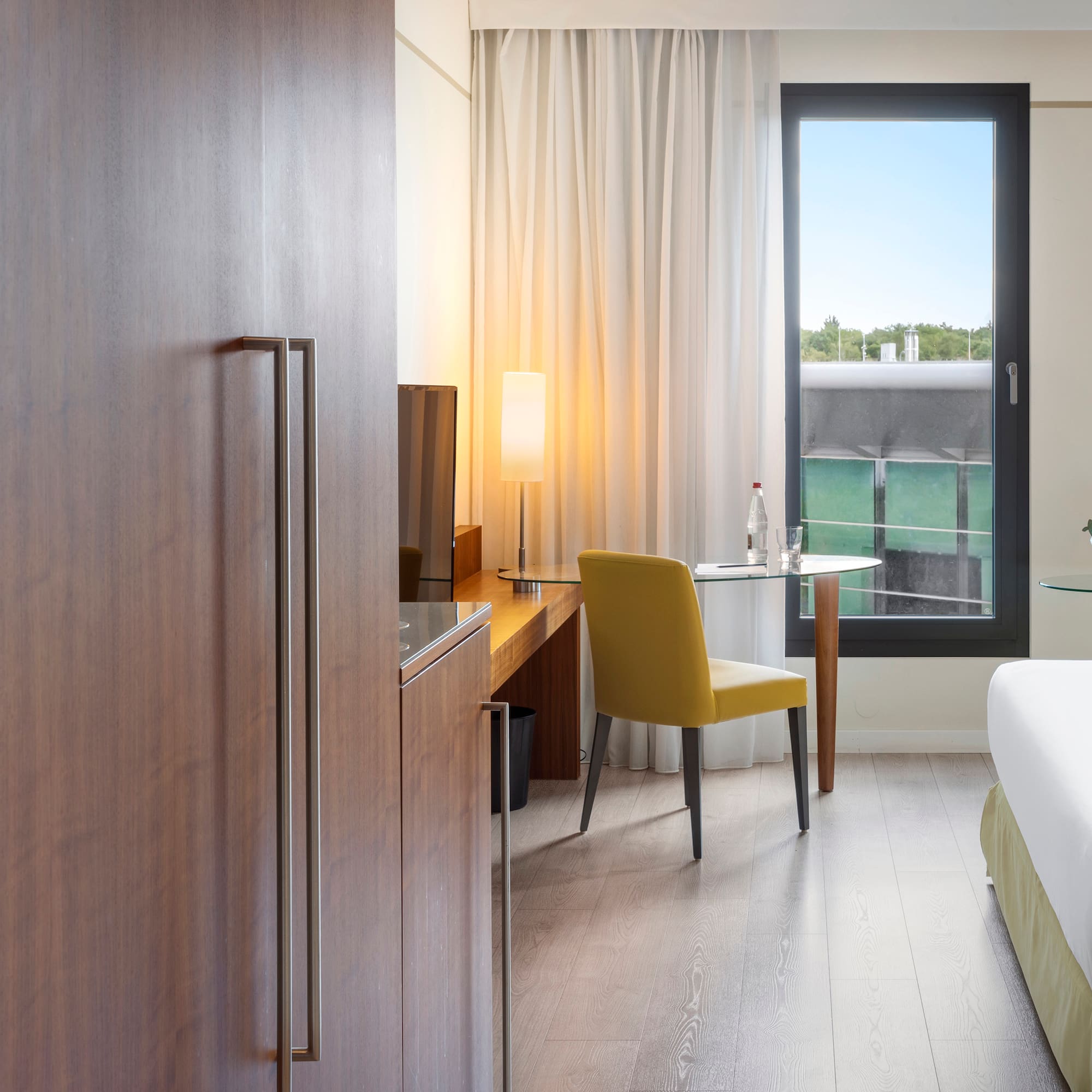 a room with a bed and a table and chair