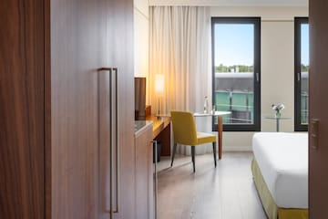 a room with a bed and a table and chair