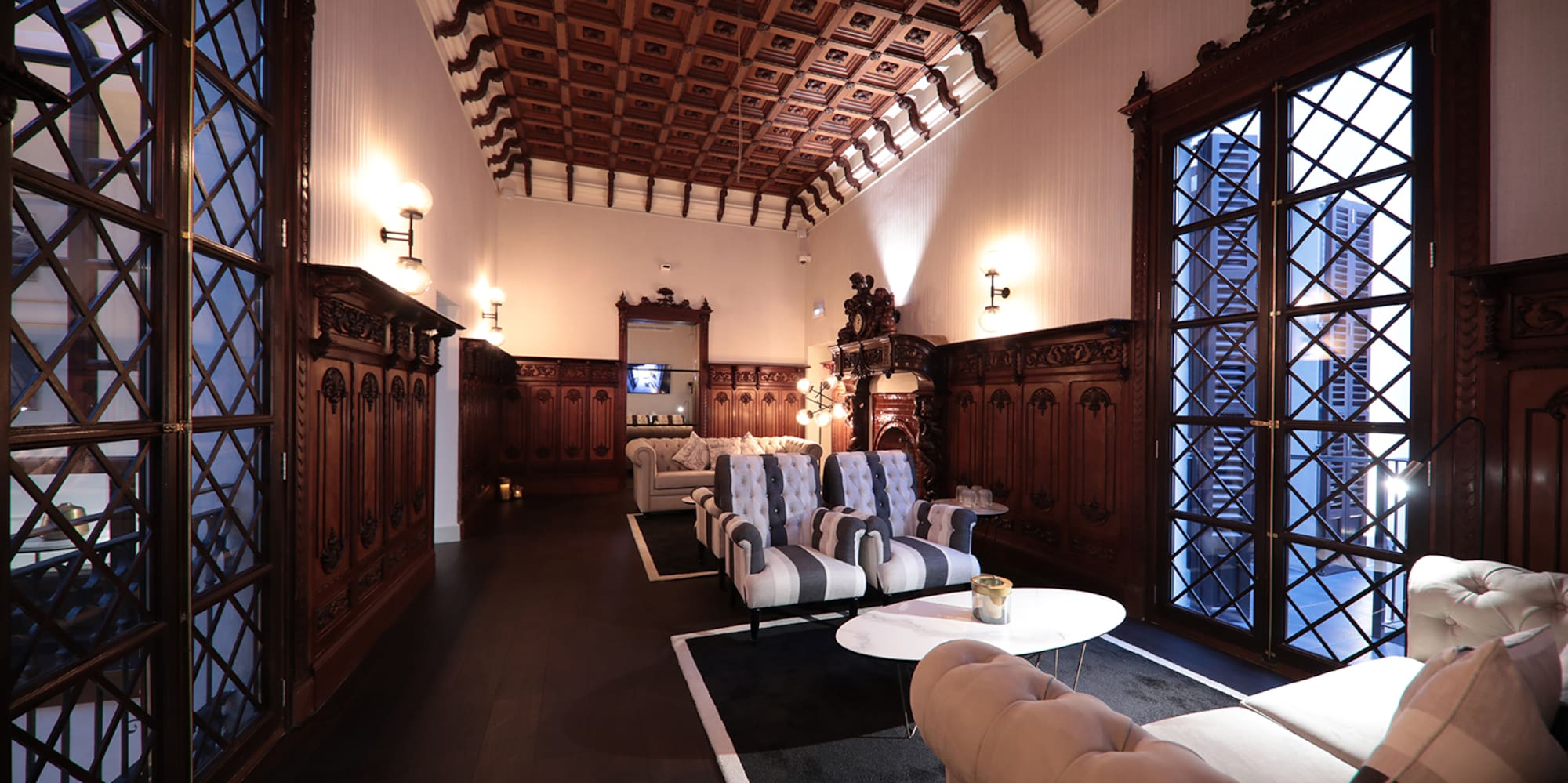 a room with a wood ceiling and a couch and a coffee table