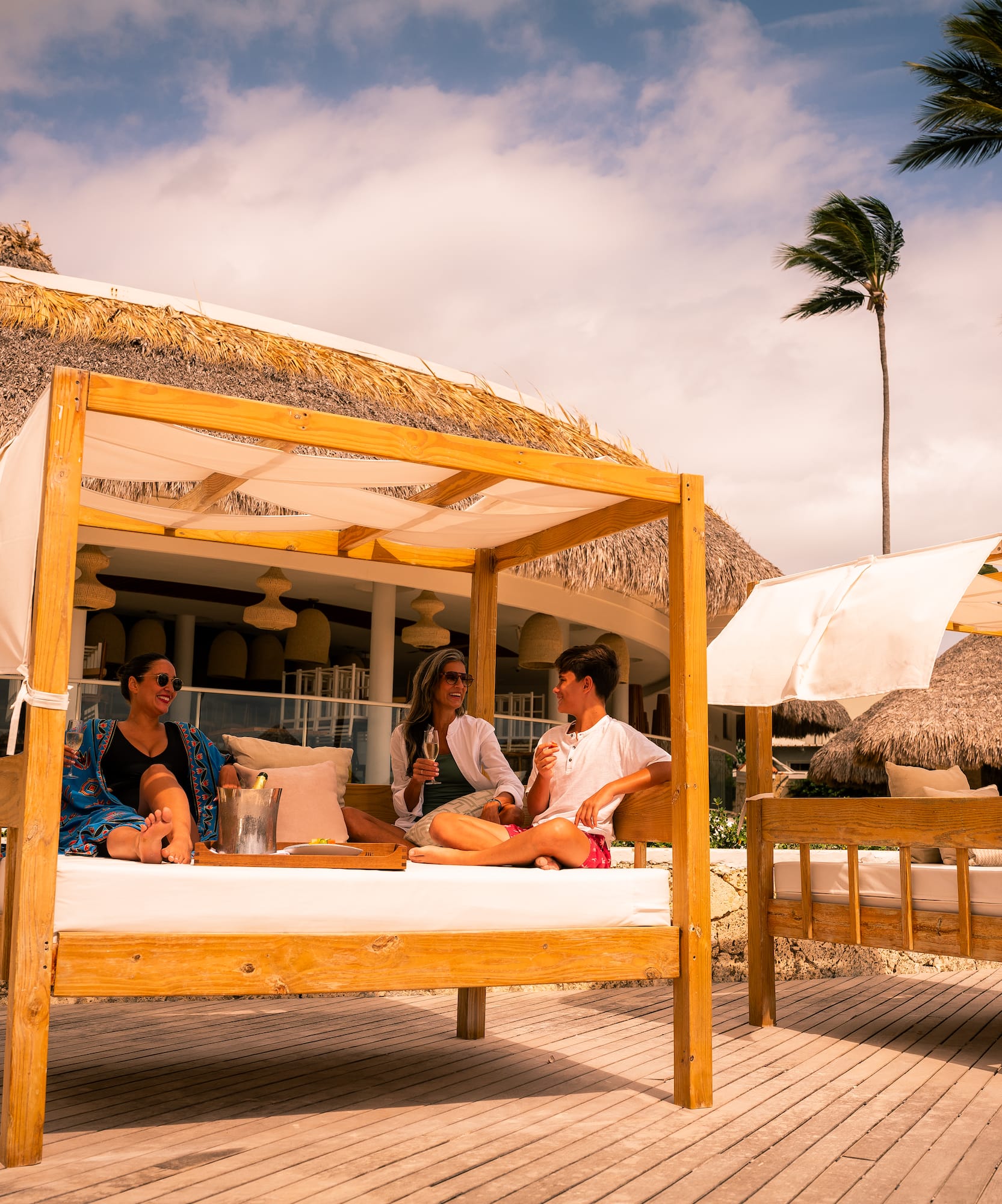 a group of people sitting on a bed outside