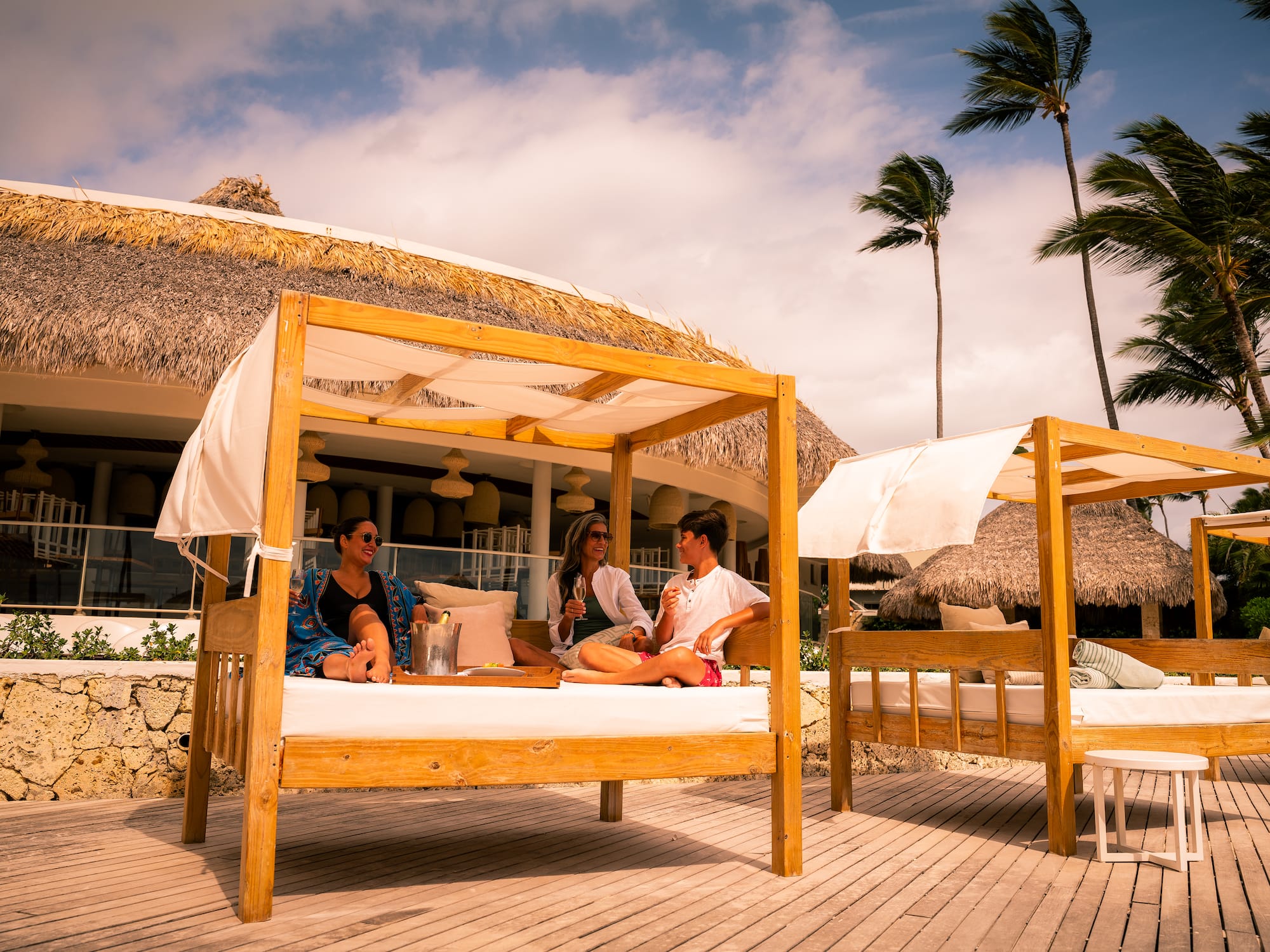 a group of people sitting on a bed outside