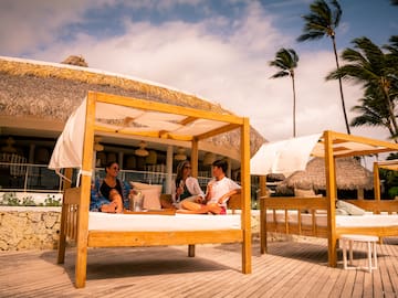 a group of people sitting on a bed outside