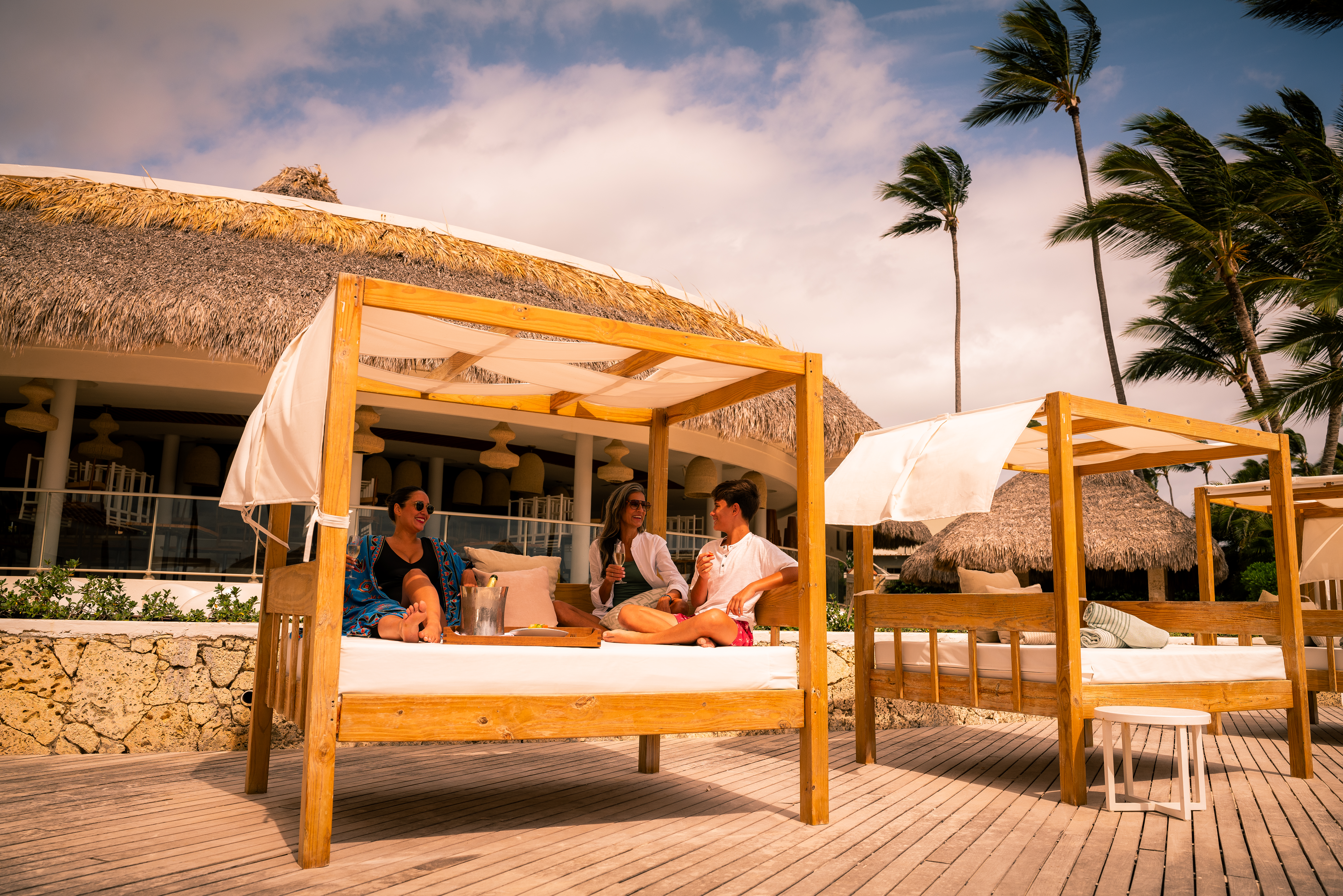 a group of people sitting on a bed outside