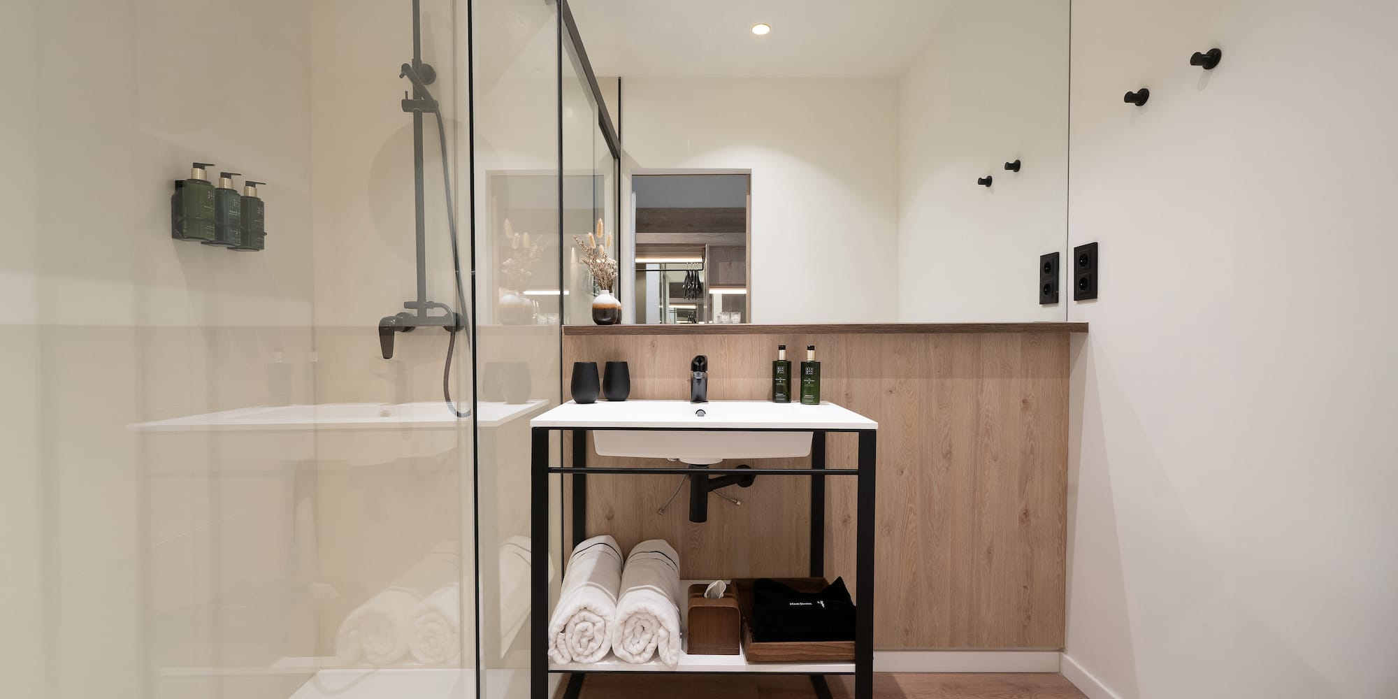 a bathroom with a shower and a sink