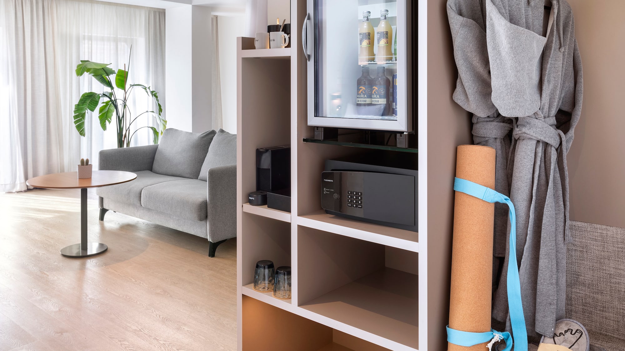 a room with a small refrigerator and a couch