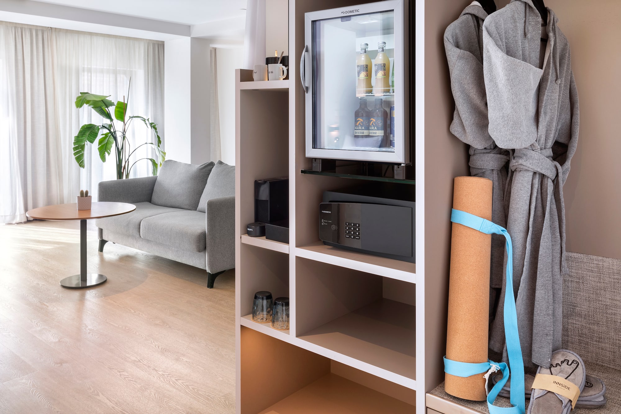 a room with a small refrigerator and a couch