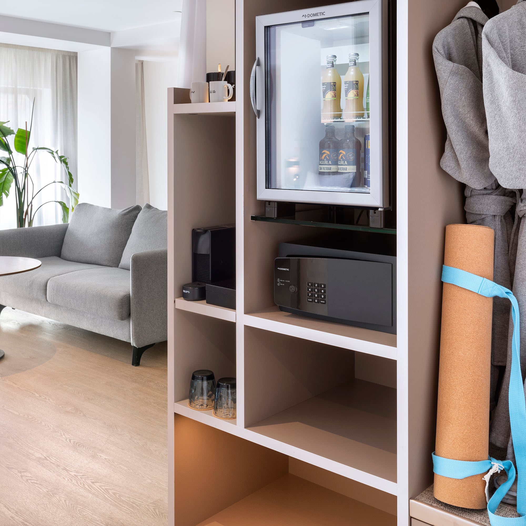 a room with a small refrigerator and a couch