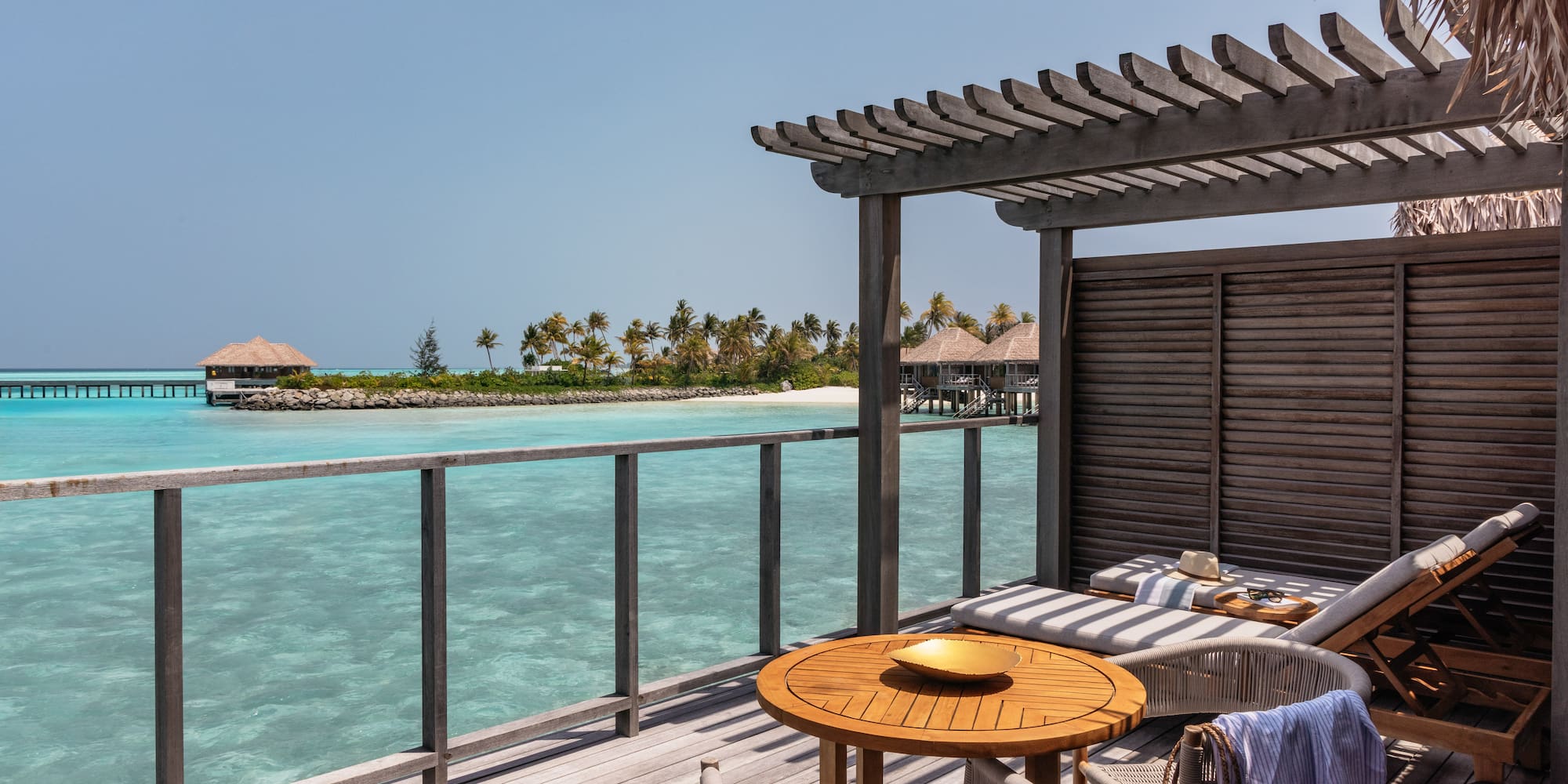 a deck with a table and chairs on it