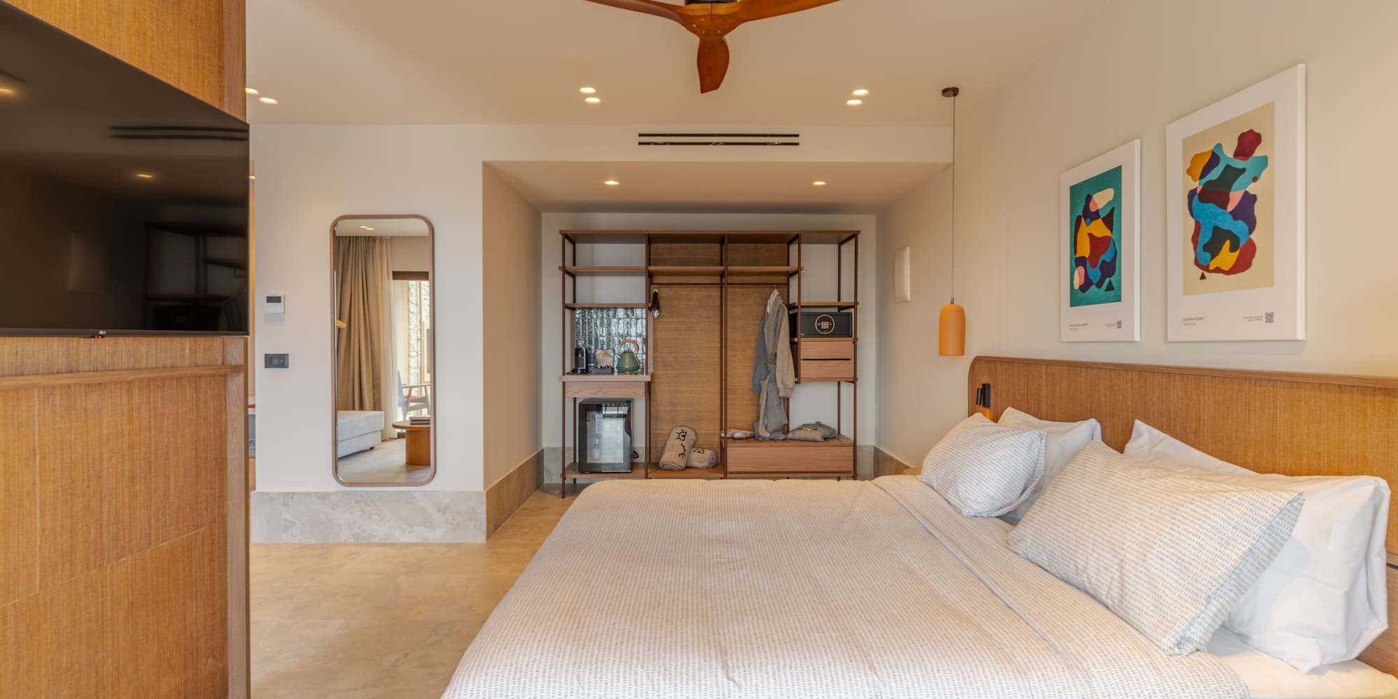 a bedroom with a large bed and a ceiling fan