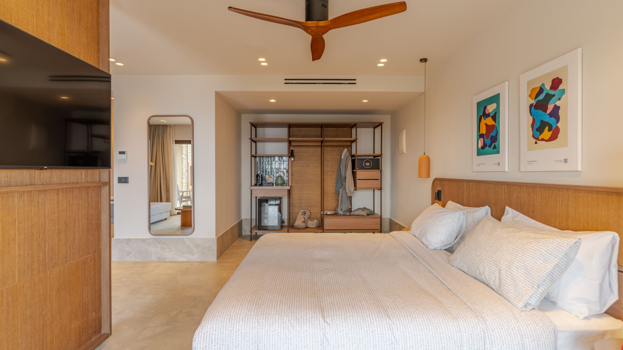 a bedroom with a large bed and a ceiling fan