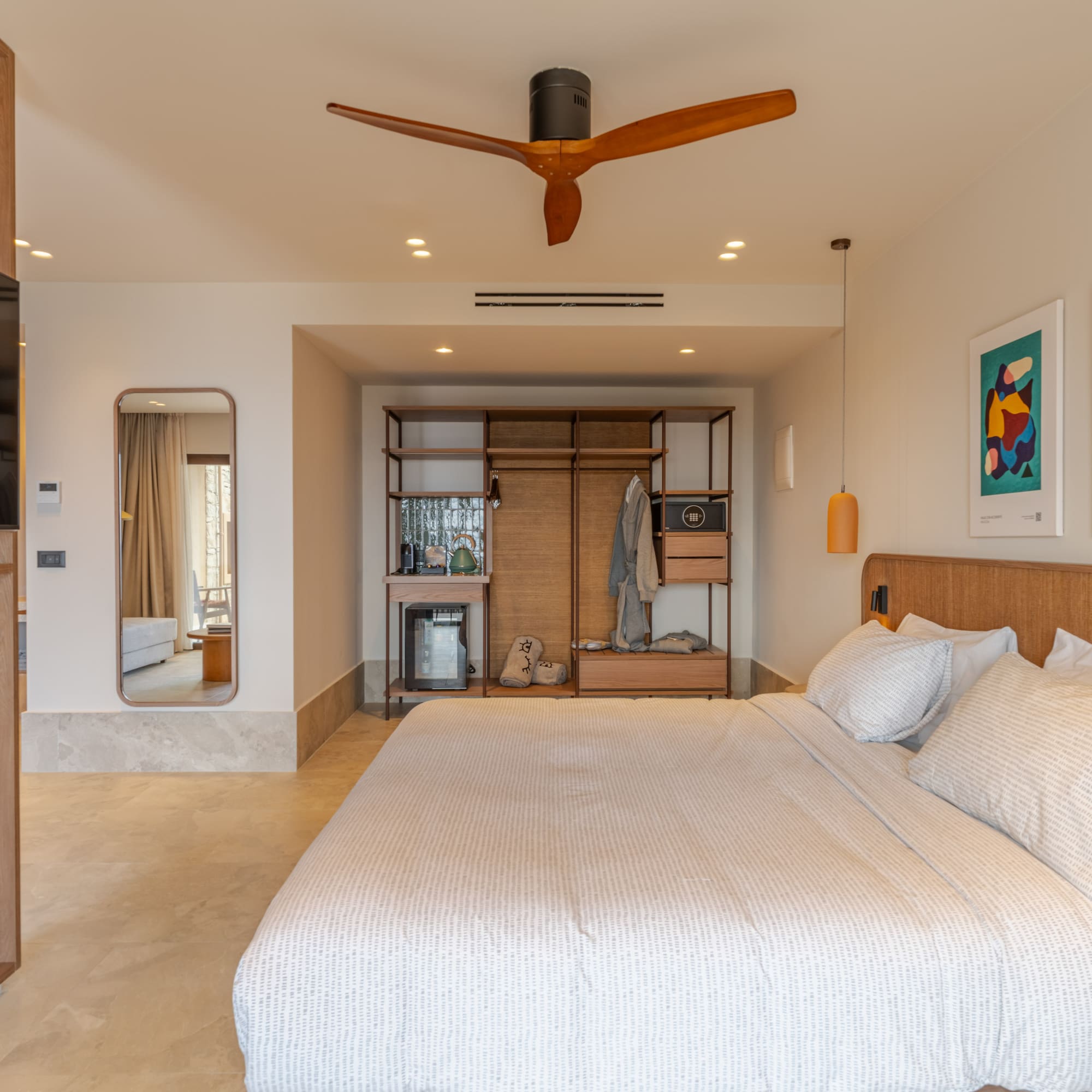 a bedroom with a large bed and a ceiling fan