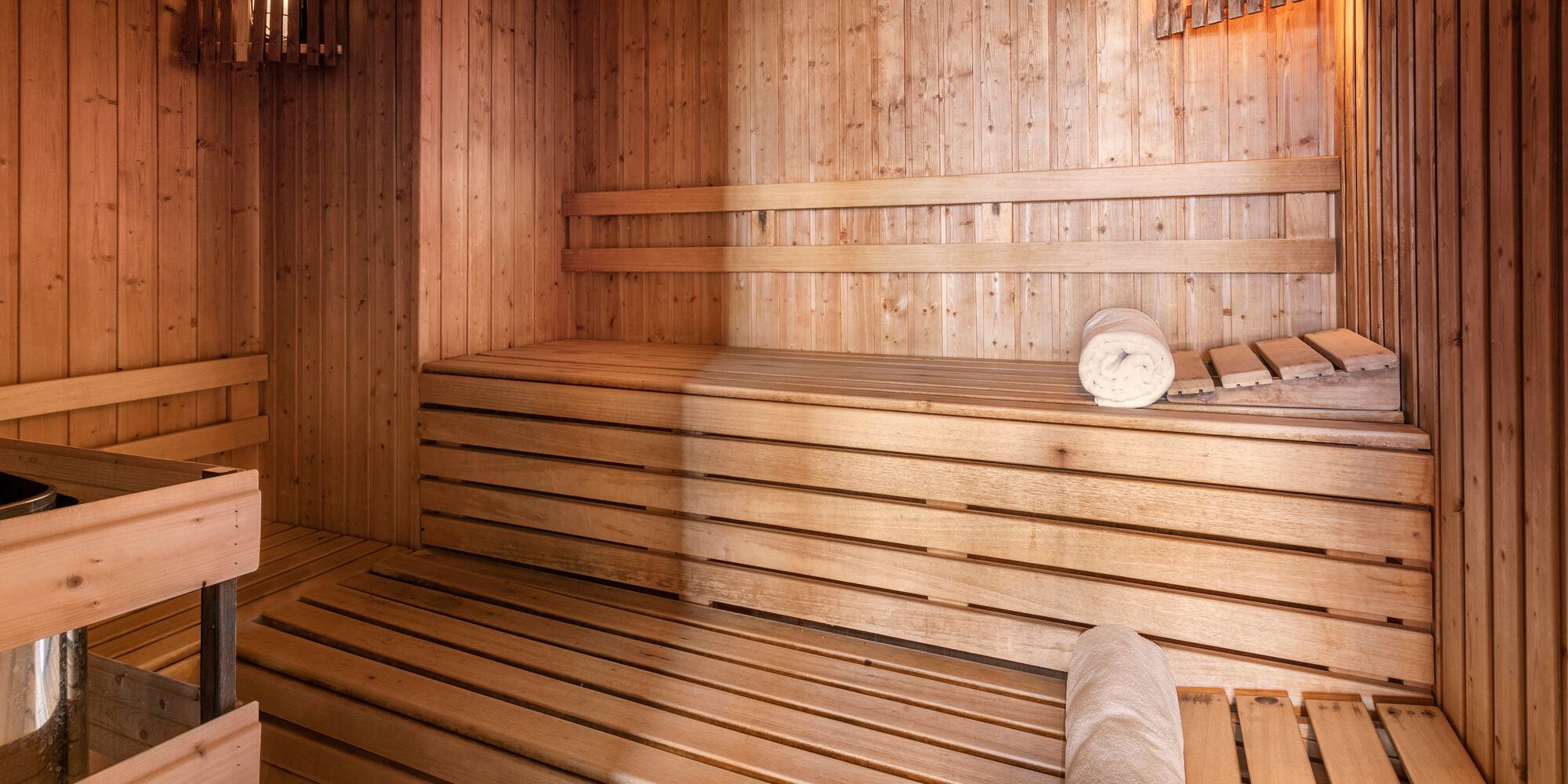 a wooden sauna with rolled towels