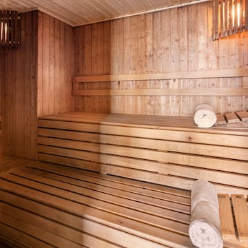 a wooden sauna with rolled towels