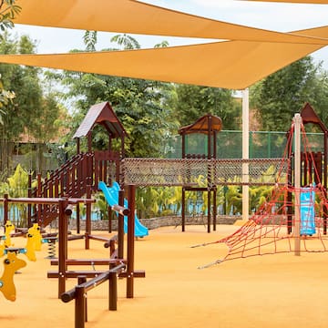 a playground with a net and yellow toys