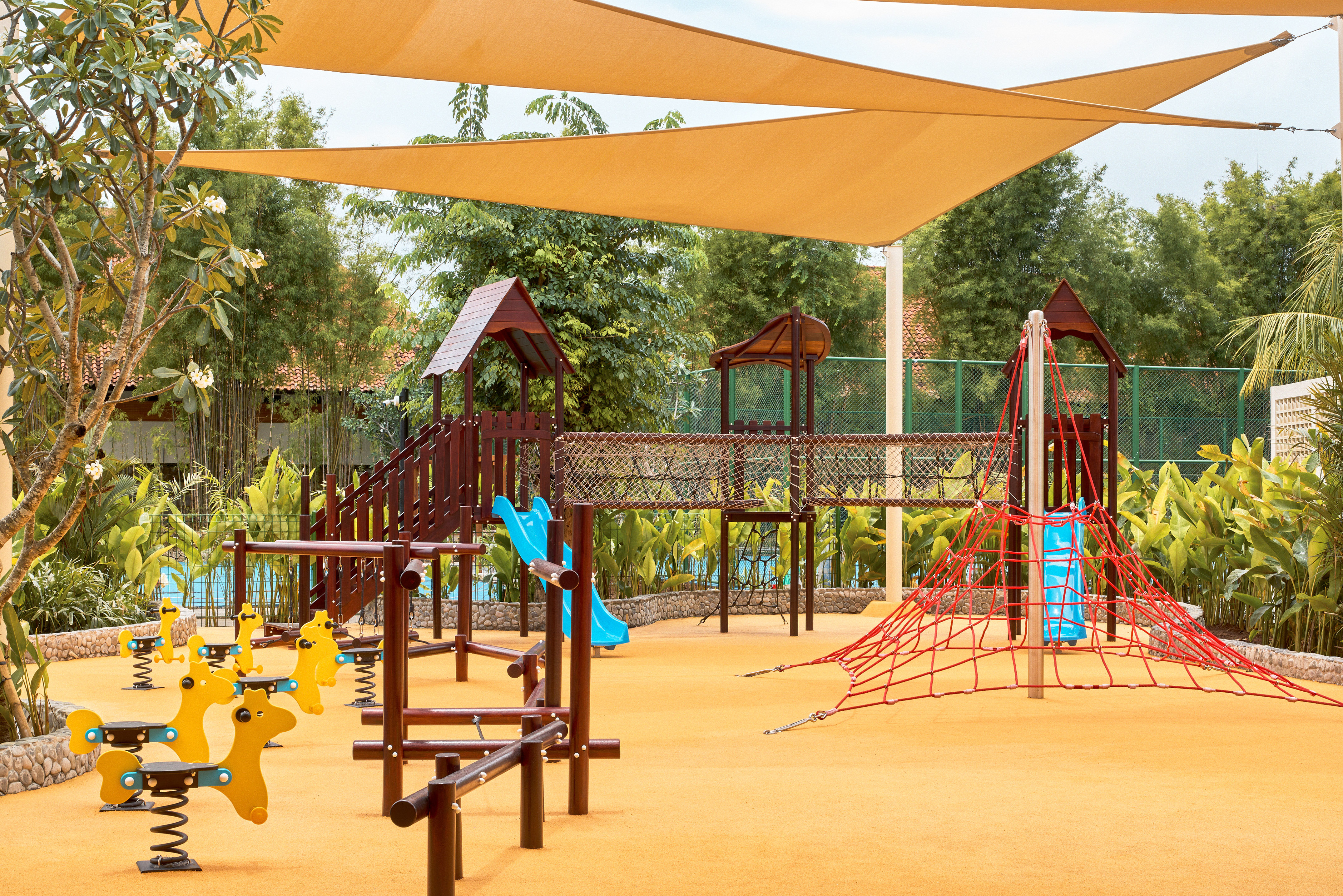 a playground with a net and yellow toys