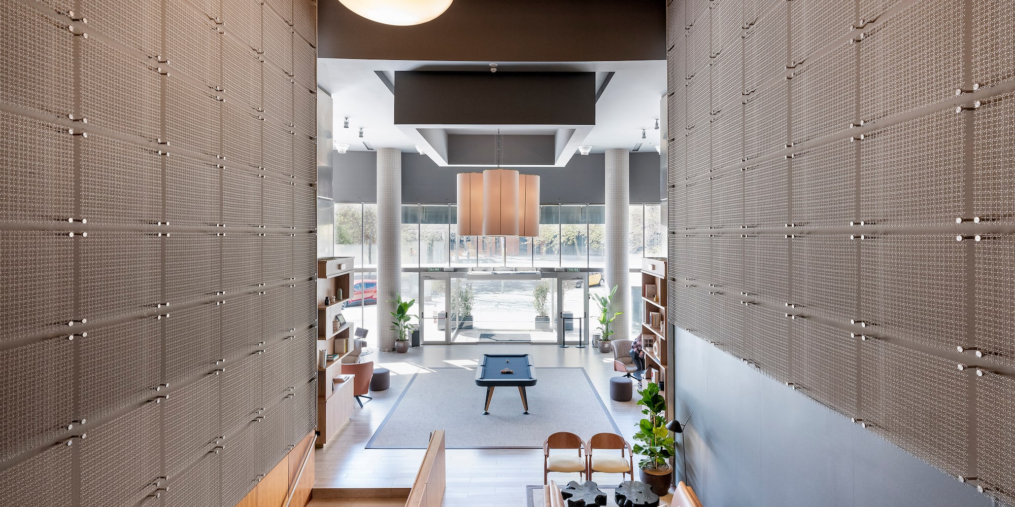 a room with a pool table and chairs