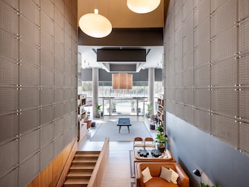 a room with a pool table and chairs