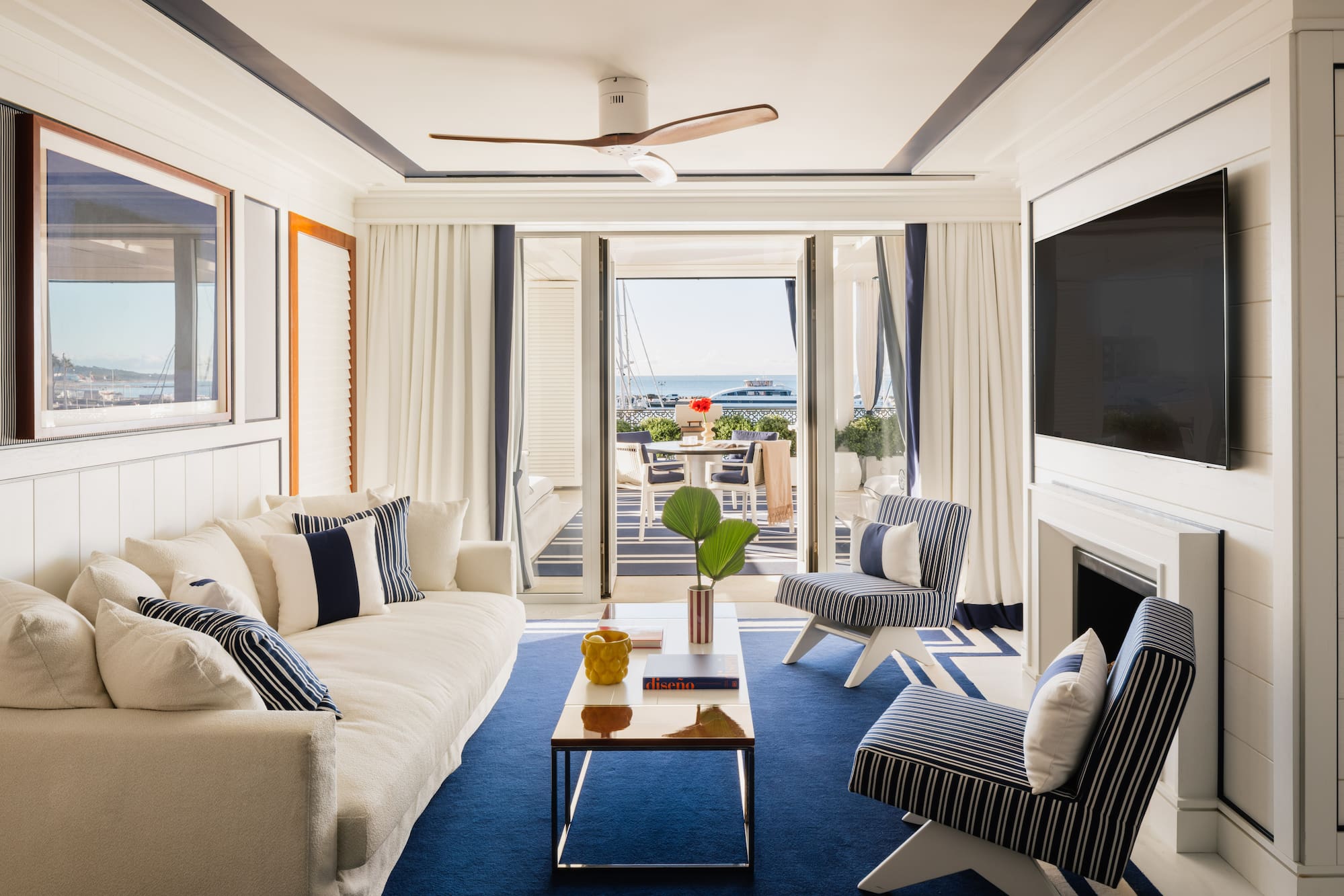 a living room with a television and a fireplace