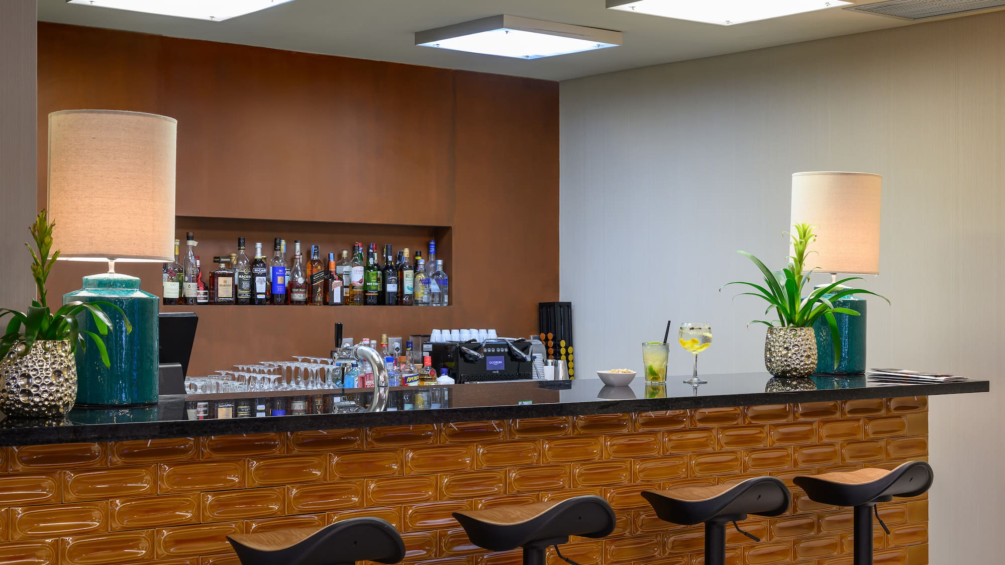 a bar with a plant and a candle on top